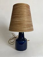 Front view showing ceramic base, power cord and woven shade