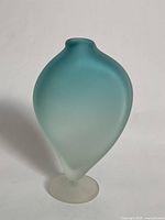 Front view of frosted blown glass vase with teal gradient and torso shape