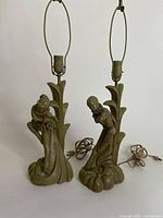 Two vintage chalkware lamps with clown figurines on painted bases, electrical cords included, shown from front