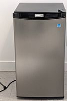 Front view of Danby Designer compact refrigerator showing silver door with black top and sides, with logo on top center and Energy Star sticker on the upper right.