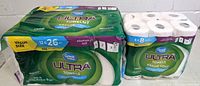 Two packs of Great Value Ultra Paper Towels, 12 rolls pack and 6 rolls pack, sealed in original packaging.