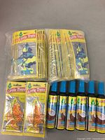 24 packs of sliced styled Little Trees hanging air fresheners and 6 blue capped spray bottles of Caribbean Colada scent