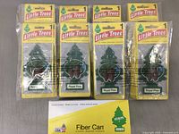 Multiple Little Trees Royal Pine hanging air fresheners, green tree shape with pine cone illustration, packaged in yellow branded cards.