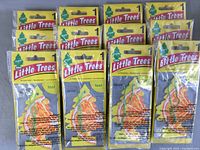 Lot of multiple packaged Little Trees Sliced hanging car air fresheners stacked together showing packaging and bulk quantity.