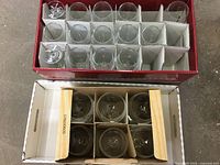 Top view of all 14 wine glasses neatly packed in a cardboard box with individual slots for each glass.