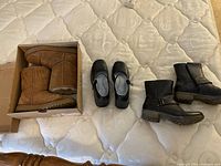 All three pairs of shoes displayed, two boots, one Mary Jane shoe.