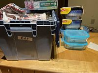 Full lot overview including Ball jar carton, plastic containers stacked, and large plastic storage bins underneath