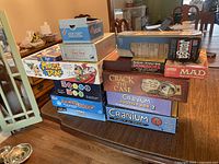 Photo showing a variety of boxed board and card games stacked on a table