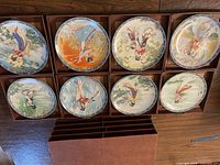 Eight 8.5 inch vintage collector plates with Asian women in traditional attire, arranged with 8-drawer cardboard case