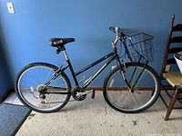 Full side view of the green Schwinn Frontier GS mountain bike showing front basket, tires, seat, and frame.