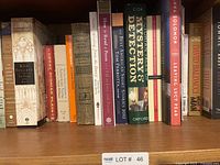 Shelf of assorted books showing mixed genres and authors with varied spine colors and sizes.