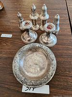 Overview of all items: bowl at front, candlesticks mid, shakers in back
