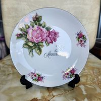 Front view of floral 25th Anniversary plate on stand