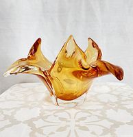 Front view showing amber blown glass centerpiece with three flared points