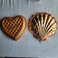 Heart and shell copper molds side by side