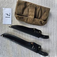 Two Rapala knives in leather sheaths and canvas pouch overall view