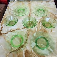 Top view of all seven green uranium glass pieces