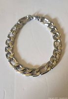 Bracelet coiled showing curb links and clasp