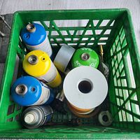 Top view of crate showing cylinders, tape rolls, aerosol can