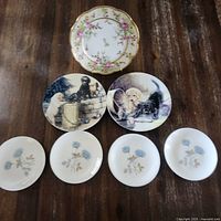 All seven plates laid out showing designs and quantity