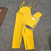 Yellow bib overalls and packaged coat/hood laid out