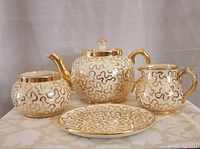 Front view of complete four-piece Sudlow's tea set showing pattern and form
