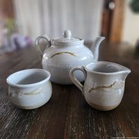 Teapot, sugar bowl, creamer frontal view