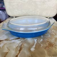 Side view showing blue Pyrex dish with clear lid