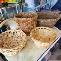 Group shot of four wicker baskets on table