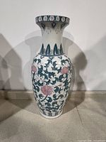 Full front view of the tall Chinese vase showing body pattern and shape