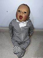 Front view of the doll seated, showing outfit and overall size