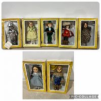 Seven vintage Effanbee dolls in original yellow boxes lined up against a wall, displaying front of packaging and visible dolls.