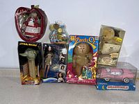 Full view of the vintage toys collection including dolls, plush, Star Wars Pez dispenser, flower toy, and pink car