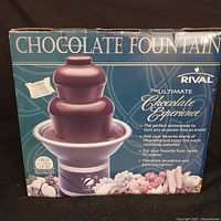 Original box showing Rival brand chocolate fountain, model 'The Ultimate Chocolate Experience' with product features and images.