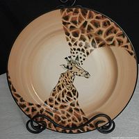 Front view of 12 inch ceramic platter hand painted with a giraffe design, showing the giraffe head and neck with detailed spots and shading.