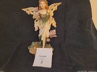 Full length image of the Veronese fairy figurine showing standing pose with wings extended and butterfly in hand.