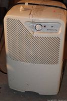 Front view of the white Simplicity 28 dehumidifier with control knob and vented front panel.