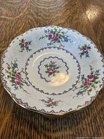 Single mosaic floral pattern saucer with gold trim