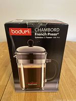 Front and side view of boxed Bodum Chambord French Press Coffee Maker, showing branding, model, cup and capacity size