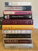 Stack of 10 books showing titles and authors on spines