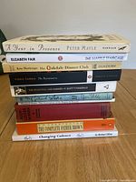 Stack of 11 assorted books showing titles and authors.