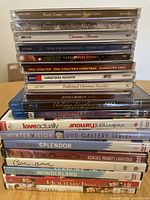 Stack of Christmas music CDs featuring titles by Perry Como, Josh Groban, Phil Coulter, and others