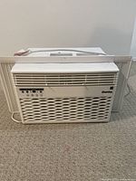 Front view of white Danby window air conditioner showing control panel and front vents.