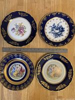 Top view of all 4 decorative plates arranged in a square with a ruler showing approximate diameter scale.