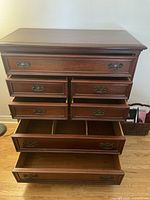 Front view of the Gibbard mahogany dresser showing all 7 drawers, some open to display interior.