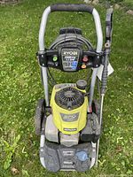 Front view showing Ryobi 2800 PSI/2.3 GPM control panel, Honda engine cover and hose reel