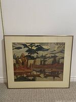 Front view of framed landscape wall art showing artwork under glass with metal frame and ruler for size reference.