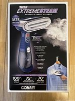 Front of box showing product image and main features including 1875 watts power, 5 steam settings, 40-second heat-up, and stand-up design