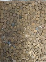View of cardboard box filled with hundreds of unsorted US pennies