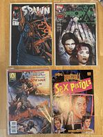 Four comic books: Spawn #7, The X-Files by Topps, Magic: The Snow Mage by Acclaim, and Rock 'n' Roll Sex Pistols.